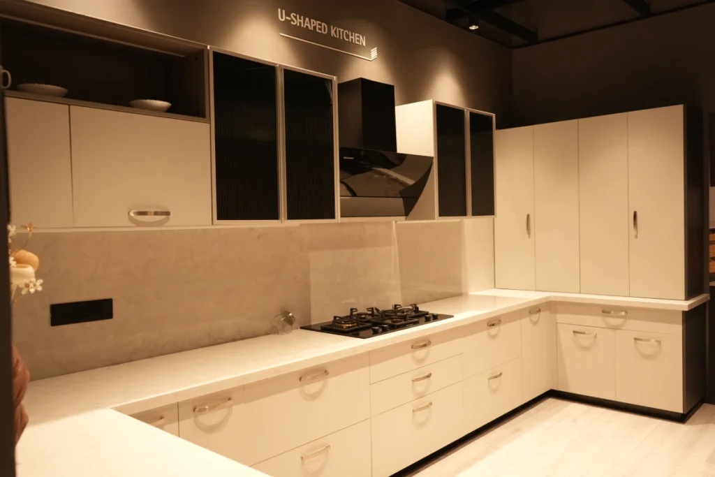 Modular Kitchen Designs 10 U-shaped modular kitchen with cream cabinets and built-in gas cooktop.